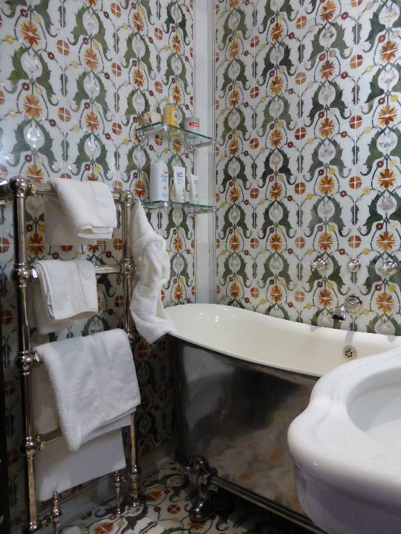 Bathroom walling in white carrara marble tiles inlaid with pietra dura and mother of pearl, 2011