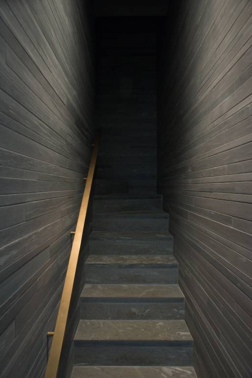 Staircase in vals stone with brass handrail, 2013