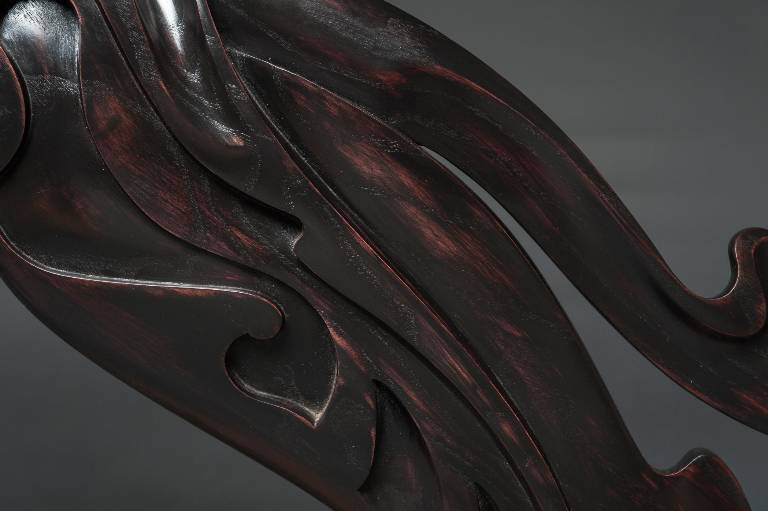 close up showing the beautifully polished ebonised finish on the ash carved sculpture